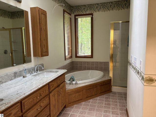 5867 Huron Woods Dr, Tawas City, MI 48763 - bathroom with a stall shower, a bath, vanity, and tile patterned floors