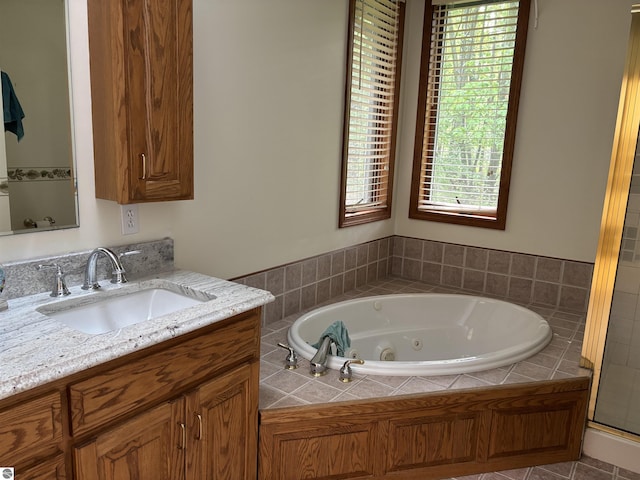 5867 Huron Woods Dr, Tawas City, MI 48763 - bathroom with vanity, a whirlpool tub, and plenty of natural light
