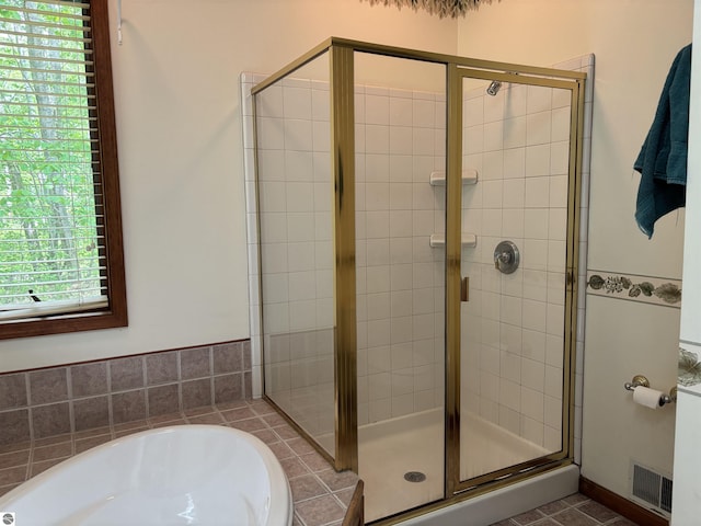 5867 Huron Woods Dr, Tawas City, MI 48763 - bathroom featuring a garden tub and a shower stall