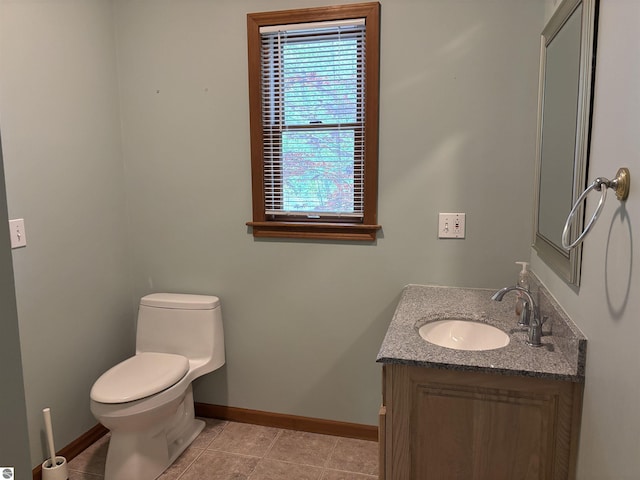 5867 Huron Woods Dr, Tawas City, MI 48763 - bathroom with baseboards, toilet, vanity, and tile patterned flooring