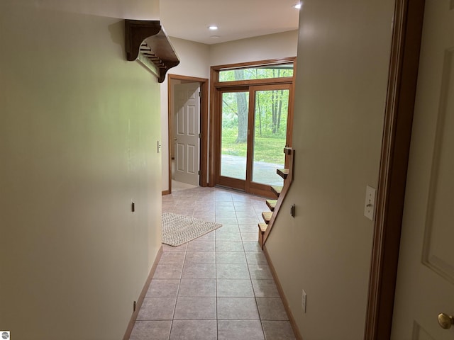 5867 Huron Woods Dr, Tawas City, MI 48763 - hall with baseboards, light tile patterned flooring, stairs, and recessed lighting
