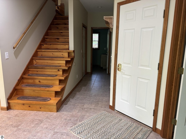 5867 Huron Woods Dr, Tawas City, MI 48763 - stairs with baseboards and tile patterned floors