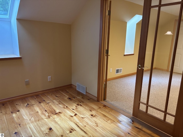 5867 Huron Woods Dr, Tawas City, MI 48763 - additional living space with hardwood / wood-style flooring and baseboards
