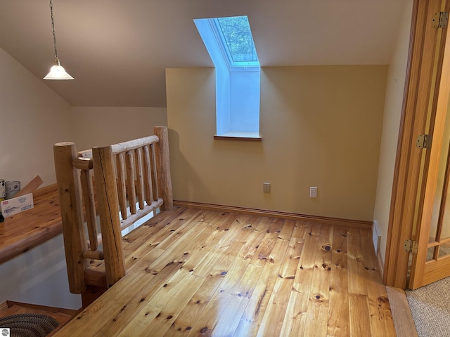 5867 Huron Woods Dr, Tawas City, MI 48763 - bonus room with a skylight, vaulted ceiling, and wood-type flooring
