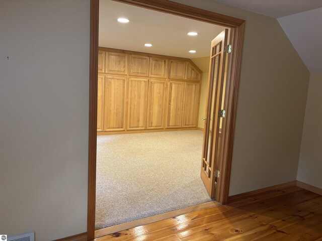 5867 Huron Woods Dr, Tawas City, MI 48763 - hallway with recessed lighting, light wood-style flooring, lofted ceiling, and baseboards