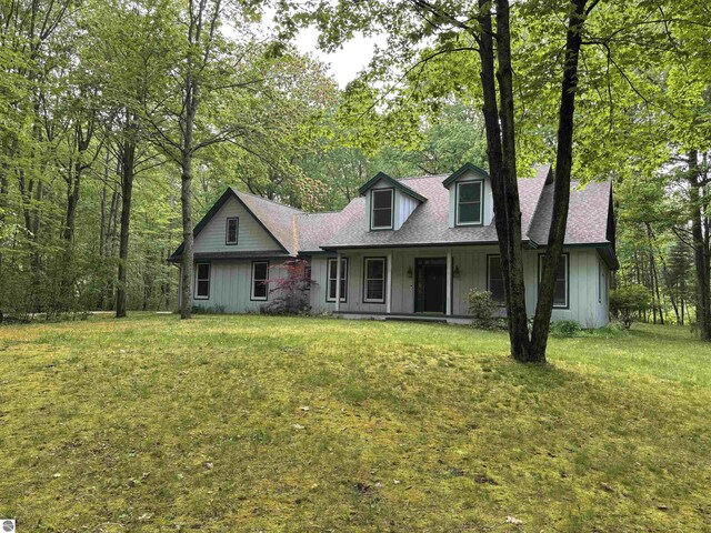 5867 Huron Woods Dr, Tawas City, MI 48763 - view of front of house with covered porch and a front yard
