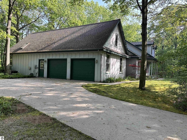 5867 Huron Woods Dr, Tawas City, MI 48763 - view of side of home featuring board and batten siding and roof with shingles