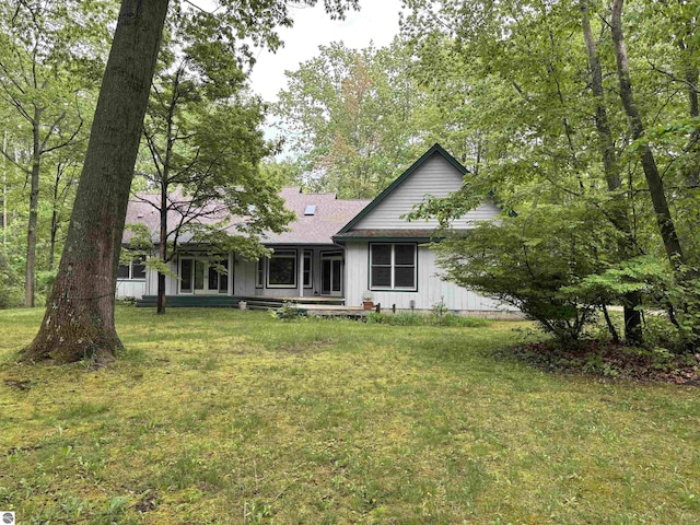 5867 Huron Woods Dr, Tawas City, MI 48763 - rear view of property featuring a lawn