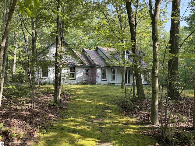 5867 Huron Woods Dr, Tawas City, MI 48763 - view of front of property featuring a front yard and a shingled roof