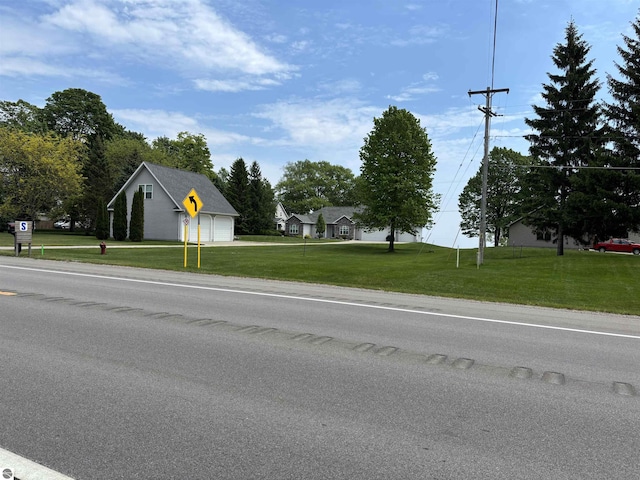 5867 Huron Woods Dr, Tawas City, MI 48763 - view of asphalt street featuring traffic signs