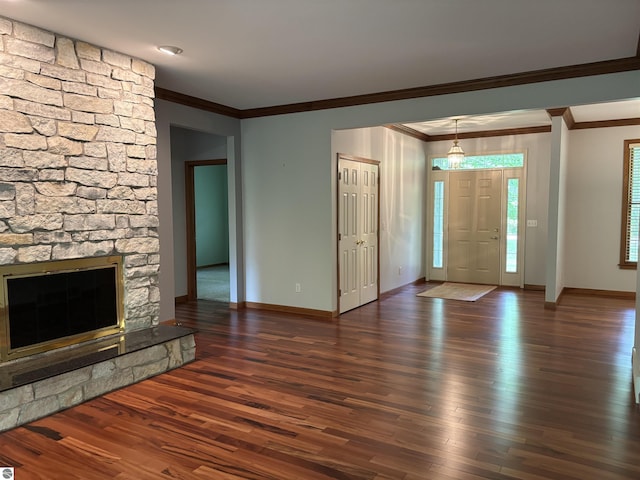 5867 Huron Woods Dr, Tawas City, MI 48763 - unfurnished living room featuring ornamental molding, wood finished floors, baseboards, and a fireplace