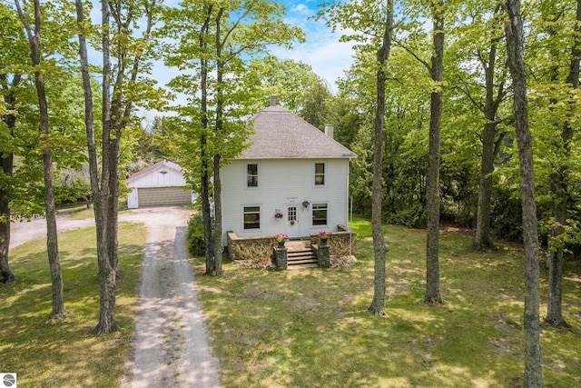 12570 N Cathead Point Rd, Northport, MI 49670 - view of side of home with an outdoor structure, a lawn, a chimney, and a garage