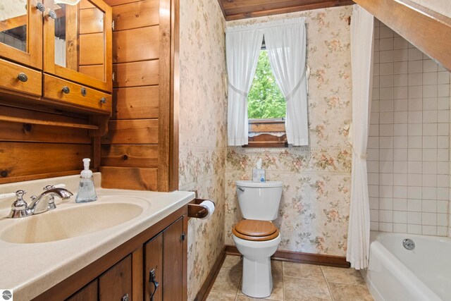 12570 N Cathead Point Rd, Northport, MI 49670 - bathroom featuring wallpapered walls, baseboards, tile patterned flooring, vanity, and toilet