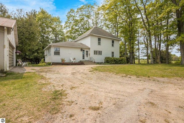 12570 N Cathead Point Rd, Northport, MI 49670 - rear view of property featuring a lawn