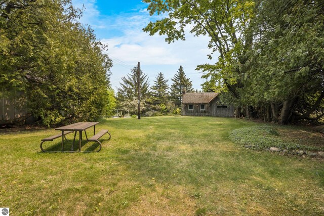 12570 N Cathead Point Rd, Northport, MI 49670 - view of grassy yard featuring an outbuilding