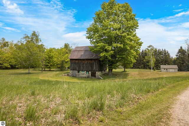 12570 N Cathead Point Rd, Northport, MI 49670 - view of yard featuring an outbuilding and a barn