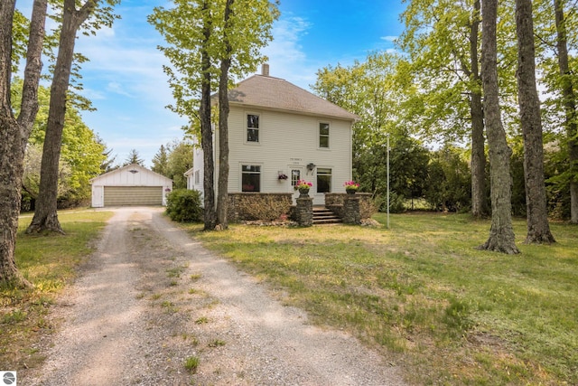 12570 N Cathead Point Rd, Northport, MI 49670 - view of side of home with an outdoor structure, a chimney, a garage, and a yard