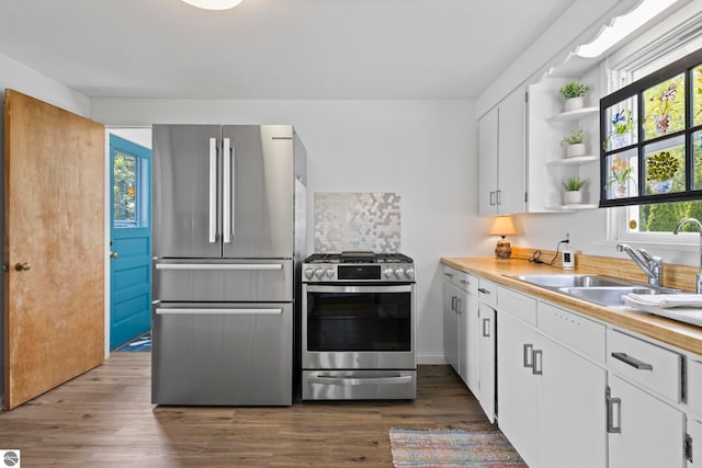 5896 S Cummings St, Suttons Bay, MI 49682 - kitchen featuring appliances with stainless steel finishes, open shelves, plenty of natural light, and white cabinets