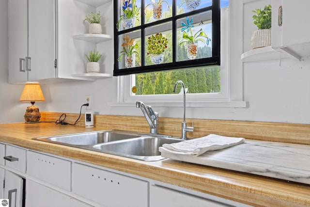 5896 S Cummings St, Suttons Bay, MI 49682 - kitchen featuring open shelves, a sink, white cabinetry, and light countertops