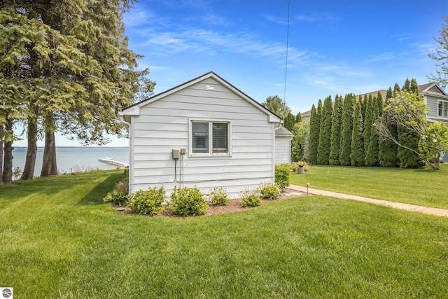 5896 S Cummings St, Suttons Bay, MI 49682 - view of side of home featuring a yard and a water view