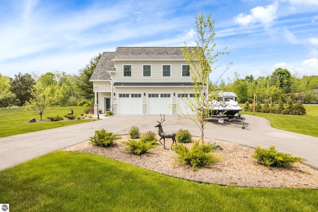 5896 S Cummings St, Suttons Bay, MI 49682 - view of front facade with a garage, a front yard, and concrete driveway