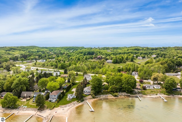 5896 S Cummings St, Suttons Bay, MI 49682 - aerial perspective of suburban area featuring a forest and a nearby body of water