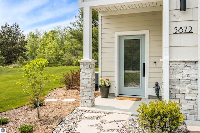 5896 S Cummings St, Suttons Bay, MI 49682 - view of exterior entry featuring a lawn