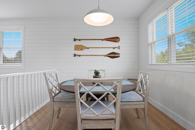 5896 S Cummings St, Suttons Bay, MI 49682 - dining room featuring wood finished floors, baseboards, and wood walls