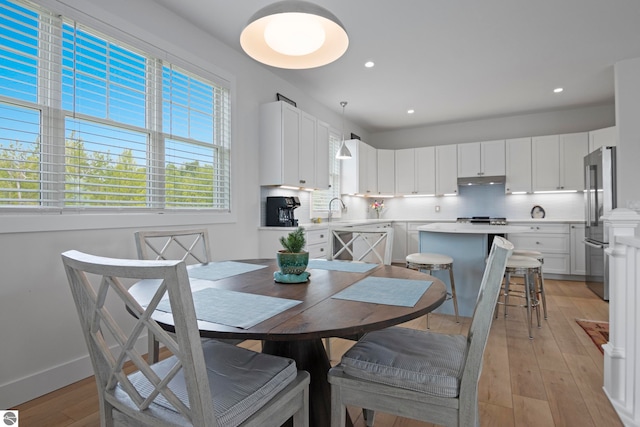5896 S Cummings St, Suttons Bay, MI 49682 - dining room featuring light wood-type flooring, recessed lighting, and baseboards