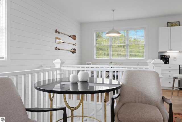 5896 S Cummings St, Suttons Bay, MI 49682 - dining space with light wood-style flooring and wooden walls