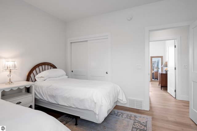 5896 S Cummings St, Suttons Bay, MI 49682 - bedroom featuring light wood-type flooring and a closet