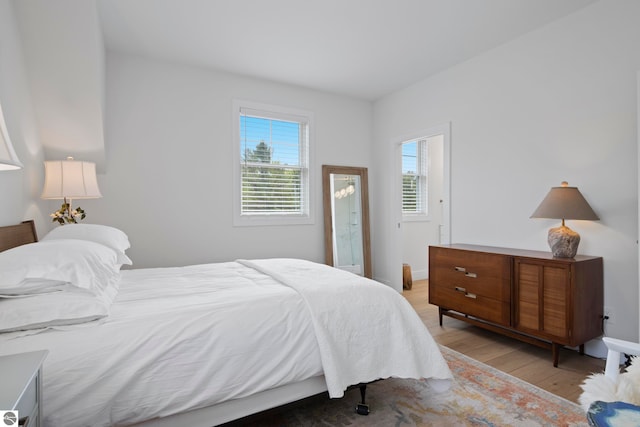 5896 S Cummings St, Suttons Bay, MI 49682 - bedroom with light wood-style flooring and baseboards