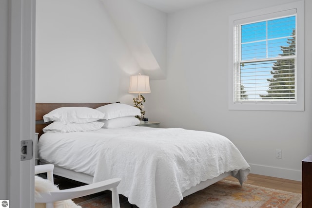 5896 S Cummings St, Suttons Bay, MI 49682 - bedroom featuring wood finished floors and baseboards