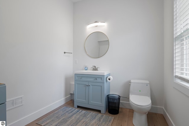 5896 S Cummings St, Suttons Bay, MI 49682 - bathroom with vanity, toilet, wood finished floors, and baseboards