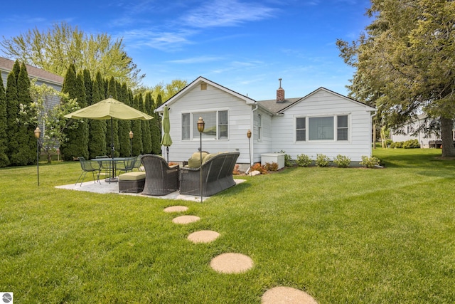 5896 S Cummings St, Suttons Bay, MI 49682 - rear view of property featuring outdoor lounge area, a patio, a lawn, and a chimney