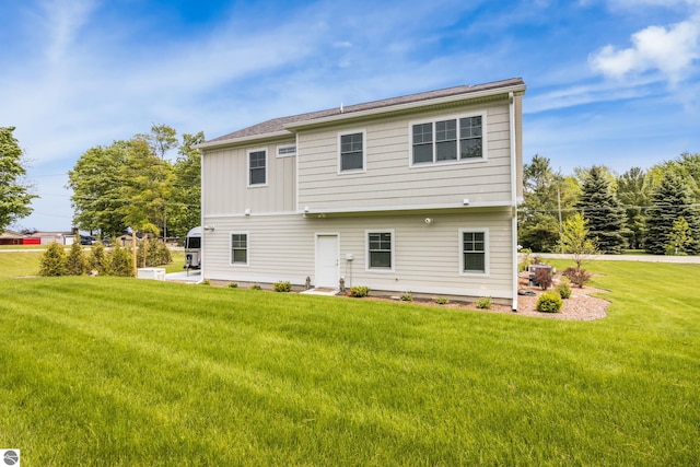 5896 S Cummings St, Suttons Bay, MI 49682 - back of property with a lawn and board and batten siding