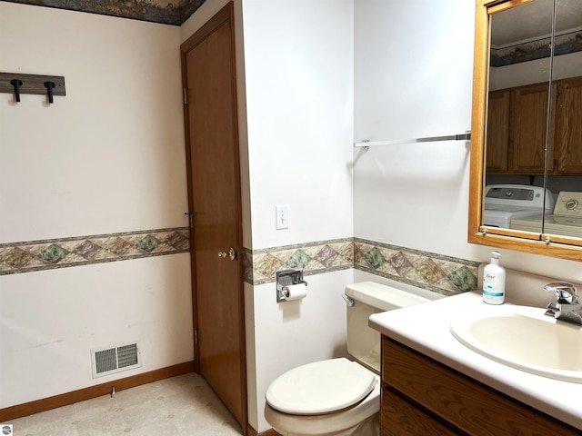 1619 E Gaylord St Unit A, Mount Pleasant, MI 48858 - half bath with vanity, washer / clothes dryer, toilet, wainscoting, and tile walls