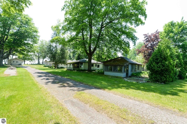 1650 N Huron, Tawas City, MI 48763 - view of front of home featuring driveway and a front yard