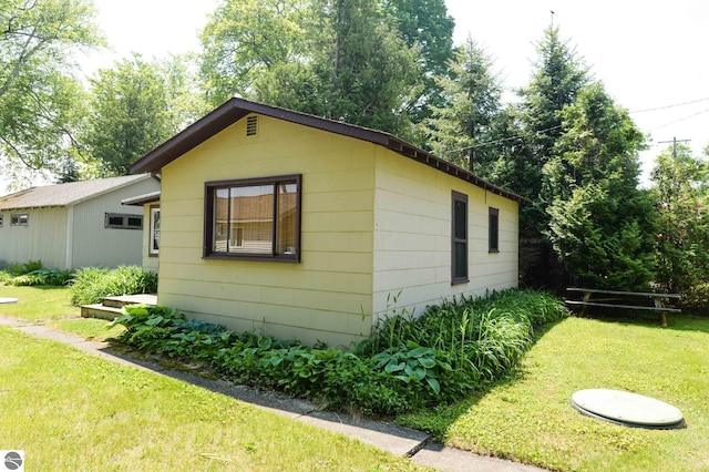 1650 N Huron, Tawas City, MI 48763 - view of property exterior featuring a yard