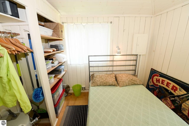 1650 N Huron, Tawas City, MI 48763 - bedroom with wood finished floors and wooden walls