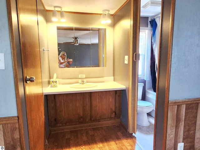 3764 E N Down River Rd, Grayling, MI 49738 - bathroom with vanity, toilet, wood finished floors, and a tub