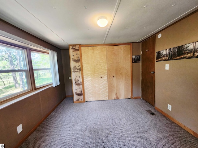 3764 E N Down River Rd, Grayling, MI 49738 - unfurnished bedroom featuring carpet, baseboards, and a closet