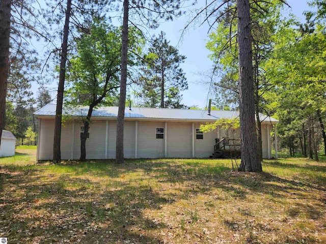 3764 E N Down River Rd, Grayling, MI 49738 - rear view of house featuring metal roof and a lawn