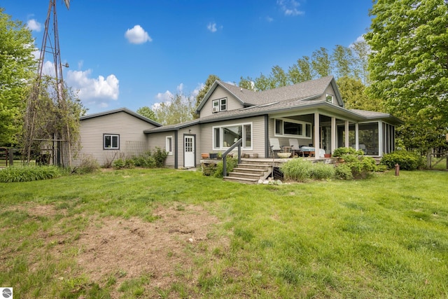 3362 S French Rd, Cedar, MI 49621 - view of front of house featuring a front yard, a shingled roof, and a sunroom