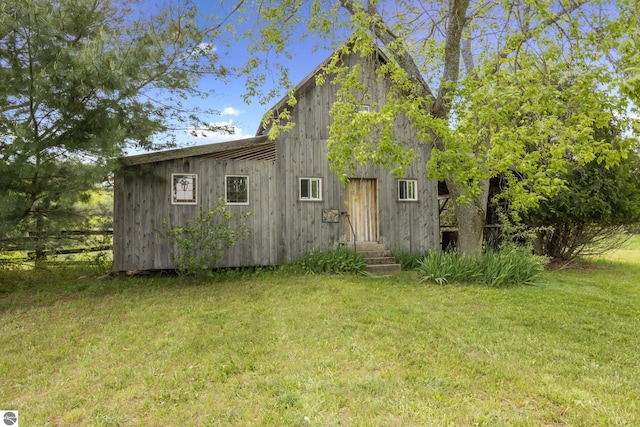 3362 S French Rd, Cedar, MI 49621 - view of side of home featuring a yard and entry steps