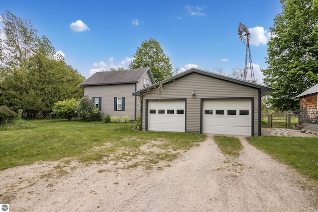 3362 S French Rd, Cedar, MI 49621 - view of front of home with driveway, an outbuilding, and a detached garage