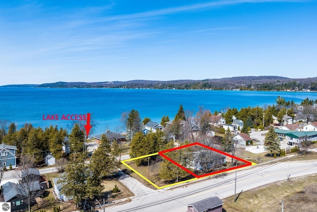 112 N Benzie Blvd, Beulah, MI 49617 - aerial perspective of suburban area featuring property boundaries highlighted and a nearby body of water