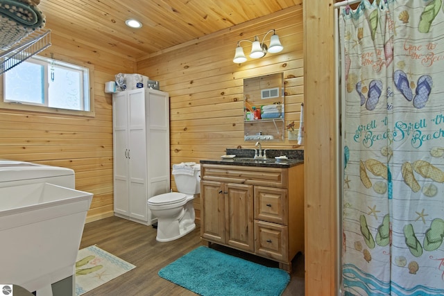 112 N Benzie Blvd, Beulah, MI 49617 - full bath featuring vanity, wooden walls, wood finished floors, recessed lighting, and washer / dryer