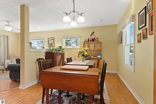 112 N Benzie Blvd, Beulah, MI 49617 - dining space featuring a chandelier, light wood finished floors, and ceiling fan