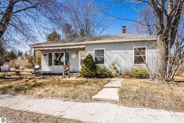 112 N Benzie Blvd, Beulah, MI 49617 - view of front of property with a chimney and covered porch